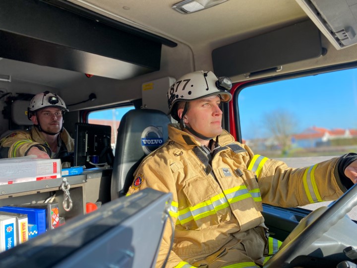 två brandmän som sitter i en brandbil 